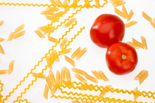 food series: uncooked pasta and ripe tomato