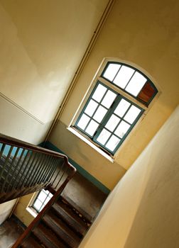 Looking down at an old wooden stairs at an abandoned building