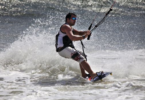 Kiteboarder enjoy surfing in ocean. Vietnam