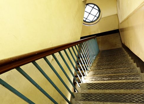 Looking down at an old wooden stairs at an abandoned building