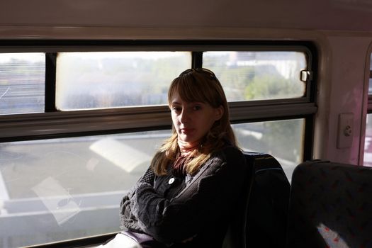 Tired woman in vintage train. The Parisian underground