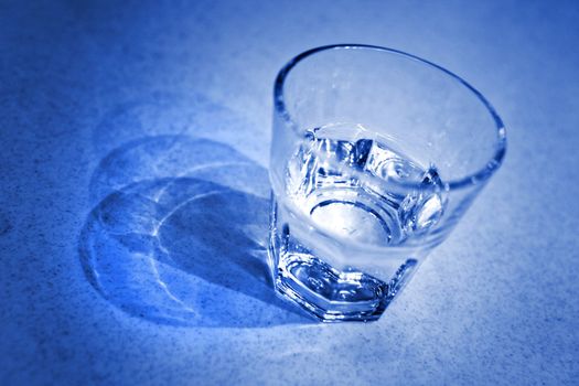 glass of water in blue tone