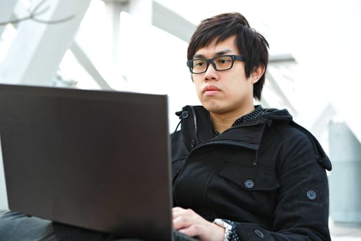 Man using computer outdoors