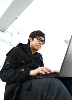 Man using computer outdoors