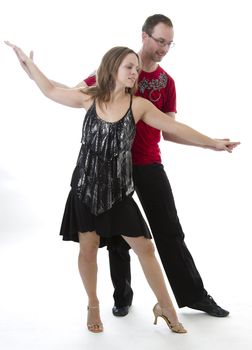 couple dancing salsa in the middle of a pose