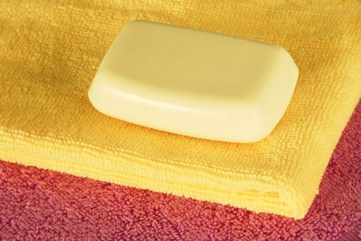 magenta and yellow towels with white soap bar