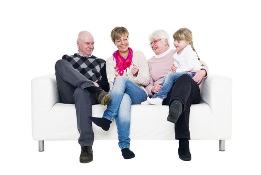 Woman with her parents and daughter in a sofa isolated on white background