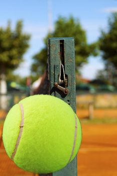 Yellow tennis ball flying in a tennis field