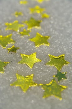 golden snow stars on a real snowy icy surface