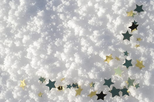 golden snow stars on a real snowy icy surface