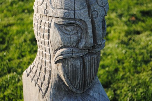 A viking figure in carved wood.