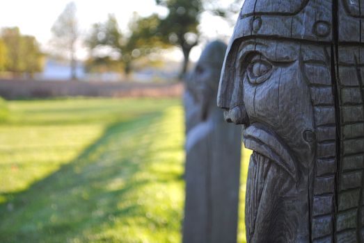 A row of wooden viking figures.