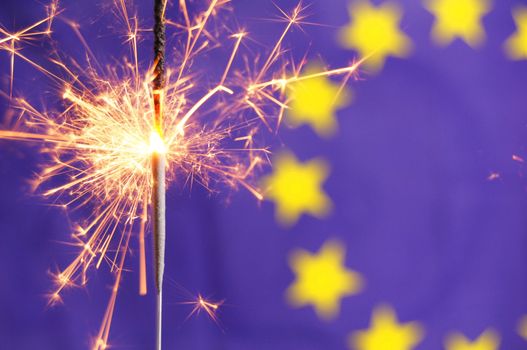 euro or european union flag and holiday sparkler showing celebration
