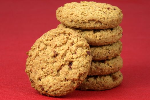 Fresh baked Stack of warm oatmeal cranberry cookies on fine tablecloth made of linen, shallow DOF