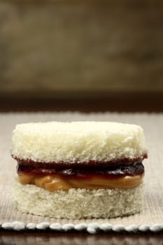 fancy and yet simple  peanut butter and jelly sandwich with old leather background  