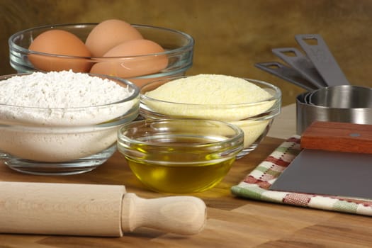 fresh raw tortellini ingredients on kitchen wood station with utensils