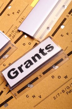 grants word on paper folder showing scholarship or higher education concept