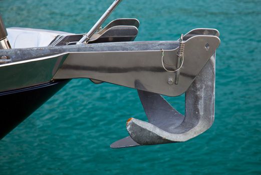 Close up of a stainless steel anchor on a large ocean going yacht