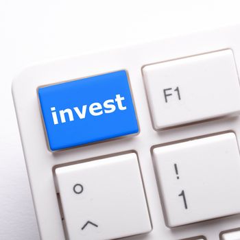 invest key on keyboard showing financial business investment concept