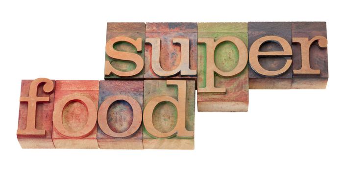 super food- words in vintage wooden letterpress printing block, stained by color inks, isolated o n white