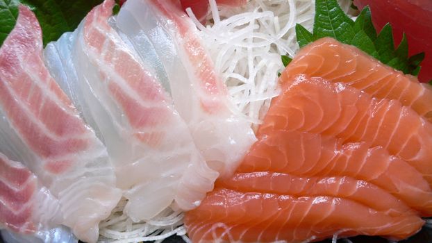 served set of japanese raw fish sashimi, macro close-up image