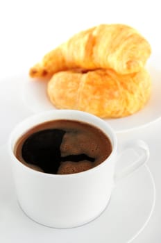 Breaksfast of black coffee and fresh croissants