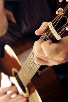 Man playing a musical instrument accoustic guitar