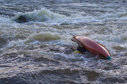 kayak is turning over in the rapid
