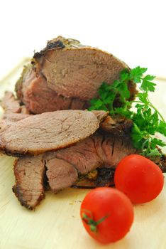 Beef roast cut on a wooden cutting board