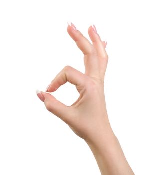 Woman's hand close-up shows a gesture ok is isolated on a white background.