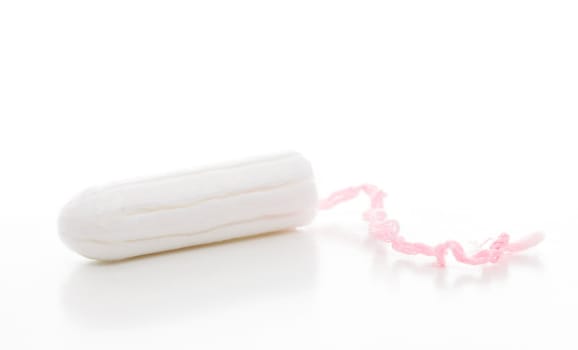 A clean cotton tampon with pink string.  White background.