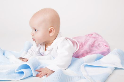 little girl with a blue towel. baby. Studio photography