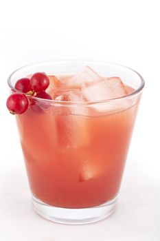 Fresh healthy red fruit juice with red currant garnish.