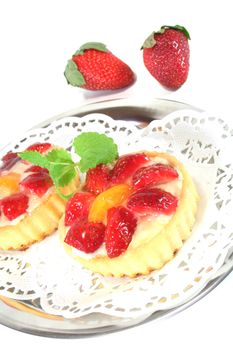 Strawberry tarts with mint on a silver platter
