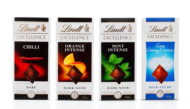 A selection of Lindt fine chocolate blocks 100g.  Varieties shown are Chilli, Orange Intense, Mint ntense and Extra Creamy Cremoso.  White background.  Editorial Use Only.