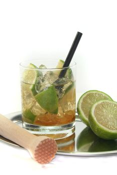 Caipirinha on a tray with fresh lime