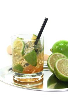 Caipirinha on a tray with fresh lime