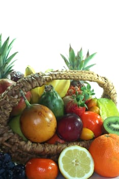 Fruit basket with various indigenous and exotic fruits on white background