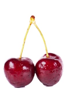 Close up view of heart shaped cherries isolated over white background