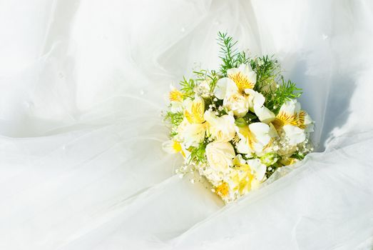 Bridal bouquet of roses on a wedding dress