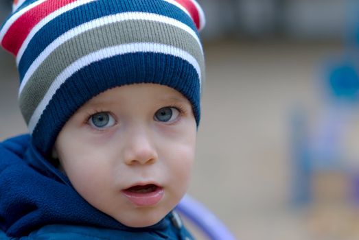 Portrait of handsome little boy on playground