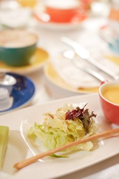 Salad on dish in restaurant in daytime.