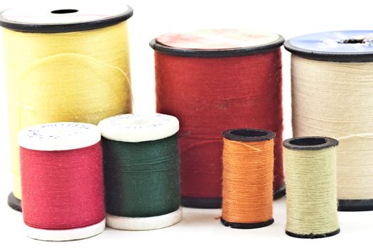Mixed colors and sizes of thread used to sew.