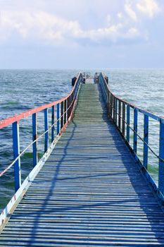 Old wooden sea pier that goes away