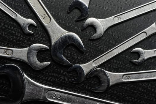 Wrenches. Wrenches on a black wooden surface