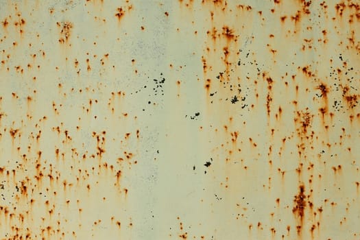 Old painted metal surface with shelled paint and rusty smudges