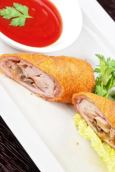 Closeup of rolls from pork meat, champignon mushroom, cheese and sauce