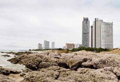 Beach, rocks, and hotels. The sea east of Thailand.