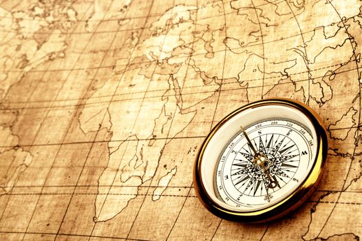 Compass on old map. Gold warm color tone