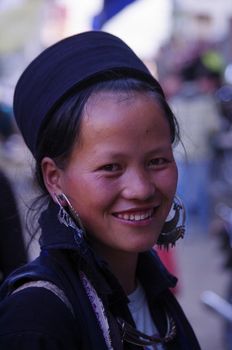 Black Hmong young women in the region of SAPA (North Vietnam). Hmong women still wear a dress. The Black Hmong women are dressed all in black. Dress, jacket and turban are black. It carries the traditional silver jewelry, earrings and necklace.